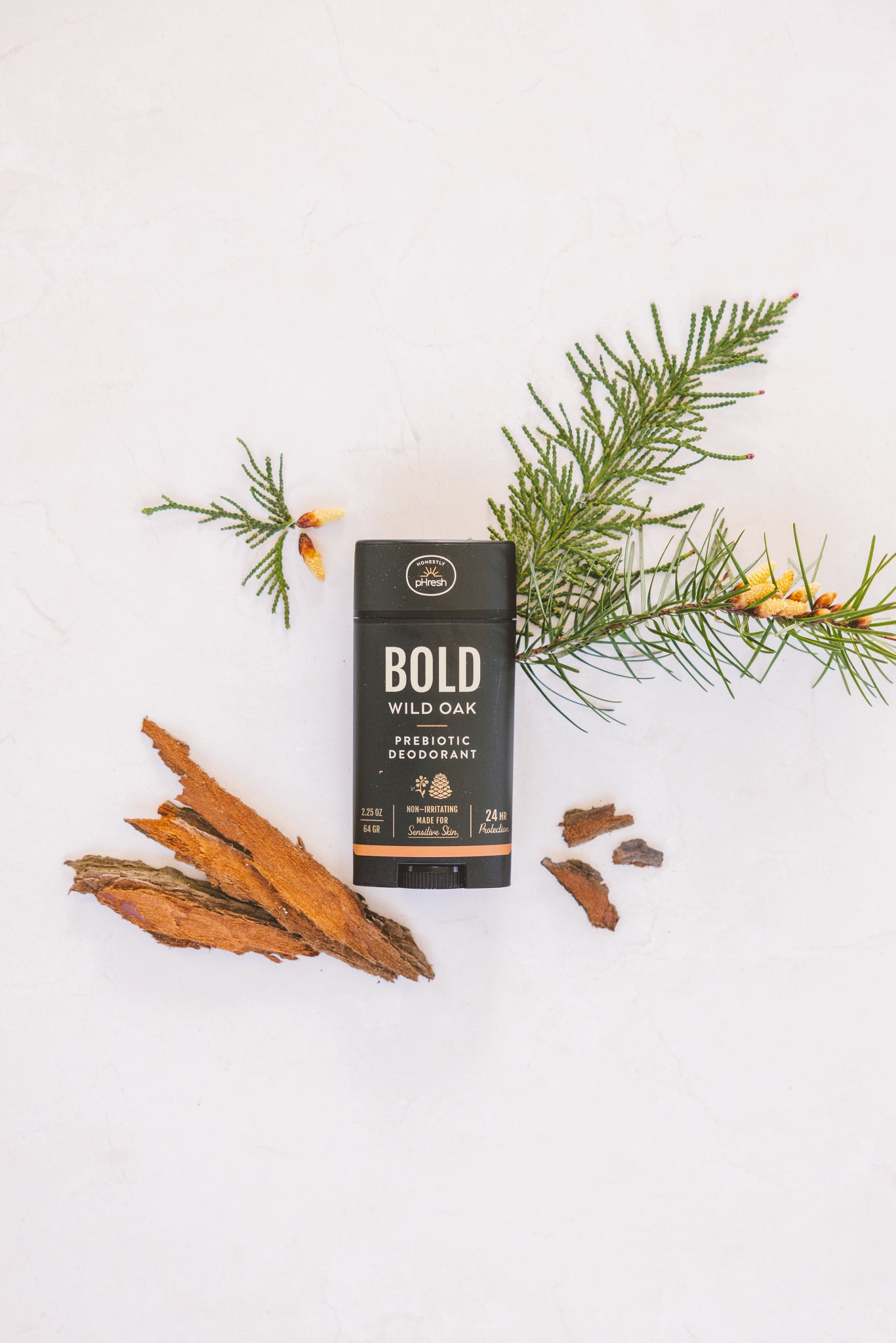Bold Wild Oak Prebiotic Deodorant with natural ingredients arrayed around it. 