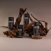 Collection of prebiotic deodorant from Honestly pHresh, including the sea mineral stick, arranged on a wooden display.